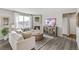 Living room with corner fireplace, hardwood floors, and white couch at 3274 Belleville Ridge Rd, Elizabeth, CO 80107