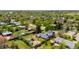 Property aerial view showcasing a white house, large yard and mature trees at 6303 W Exposition Ave, Lakewood, CO 80226