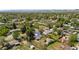 Aerial view of a suburban neighborhood featuring green lawns, mature trees, and well-maintained homes at 6303 W Exposition Ave, Lakewood, CO 80226