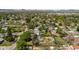 Overhead view of a neighborhood with well-maintained homes, lush green spaces, and trees at 6303 W Exposition Ave, Lakewood, CO 80226