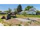 The backyard features lawn, trees, and a covered boat at 6303 W Exposition Ave, Lakewood, CO 80226