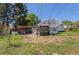 View of a backyard with a patio, pergola, and a small enclosed porch at 6303 W Exposition Ave, Lakewood, CO 80226