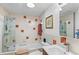 Updated bathroom features a shower-tub combo, modern tile, and new fixtures, plus toilet and sink at 6303 W Exposition Ave, Lakewood, CO 80226