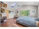 Bright bedroom features a skylight, ceiling fan, built-in shelving, and large windows for natural light at 6303 W Exposition Ave, Lakewood, CO 80226
