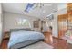 Bright bedroom features a skylight, ceiling fan, built-in shelving, and large windows for natural light at 6303 W Exposition Ave, Lakewood, CO 80226