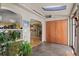Inviting entryway with tile flooring, coat closet, archways, and views into the adjacent living spaces at 6303 W Exposition Ave, Lakewood, CO 80226