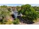Charming home with a large tree in the front yard and solar panels on the roof at 6303 W Exposition Ave, Lakewood, CO 80226