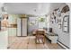 Charming kitchen with dining area, vintage-style cabinets, modern appliances, and bright lighting at 6303 W Exposition Ave, Lakewood, CO 80226