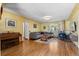 Living room with hardwood floors, piano, fireplace, and gray sectional sofa at 6303 W Exposition Ave, Lakewood, CO 80226