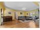 Spacious living room with hardwood floors, piano, wood burning stove, and ample natural light at 6303 W Exposition Ave, Lakewood, CO 80226