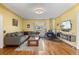 Cozy living room with hardwood floors, wood burning stove, comfortable seating, and natural light at 6303 W Exposition Ave, Lakewood, CO 80226