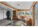 Cozy sunroom with wood accents, comfortable seating, and bookshelves, bathed in natural light at 6303 W Exposition Ave, Lakewood, CO 80226