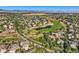 Panoramic aerial view showcasing a community near a scenic golf course with water features at 13891 Muirfield Ct, Broomfield, CO 80023