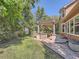 Charming backyard featuring a patio, pergola, and nicely manicured lawn at 13891 Muirfield Ct, Broomfield, CO 80023
