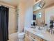 Well-lit bathroom with a shower-tub combo, light wood vanity, and neutral walls at 13891 Muirfield Ct, Broomfield, CO 80023