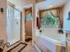Bright bathroom featuring a separate shower and tub, and large window for natural light at 13891 Muirfield Ct, Broomfield, CO 80023