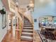 Grand foyer with a curved staircase, hardwood floors, and open access to living spaces at 13891 Muirfield Ct, Broomfield, CO 80023