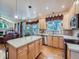 Spacious kitchen with a large island, stainless steel appliances, and hardwood floors at 13891 Muirfield Ct, Broomfield, CO 80023
