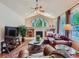 Comfortable living room area featuring a fireplace, ceiling fan, and hardwood floors at 13891 Muirfield Ct, Broomfield, CO 80023