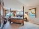Serene main bedroom features a four-poster bed and plenty of natural light from the many surrounding windows at 13891 Muirfield Ct, Broomfield, CO 80023
