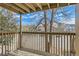 Balcony with wooden railing and an open view of a parking area at 1302 S Parker Rd # 229, Denver, CO 80231