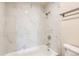 Bright bathroom featuring a white tiled shower-tub combination at 1302 S Parker Rd # 229, Denver, CO 80231