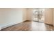 Bedroom with wood-look flooring and sliding glass door to balcony at 1302 S Parker Rd # 229, Denver, CO 80231