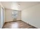Well-lit bedroom with wood-look flooring and a large window at 1302 S Parker Rd # 229, Denver, CO 80231