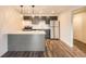 Modern kitchen featuring stainless steel appliances, gray cabinetry, and wood-look flooring at 1302 S Parker Rd # 229, Denver, CO 80231