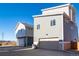 Modern townhome with a two-car garage, neutral siding, and a well-manicured lawn in a desirable neighborhood at 46537 Avery Ln, Bennett, CO 80102