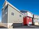 Modern townhome with a two-car garage, neutral siding, and large windows for natural light at 46537 Avery Ln, Bennett, CO 80102