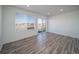 Spacious living room is filled with lots of natural light, thanks to the large window and glass sliding door at 46537 Avery Ln, Bennett, CO 80102