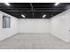 Unfinished basement with gray carpet, white walls, and black exposed ceiling at 7500 E Dartmouth Ave # 8, Denver, CO 80231