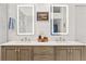 Elegant bathroom featuring a dual vanity and framed mirrors, with a walk in shower at 7500 E Dartmouth Ave # 8, Denver, CO 80231