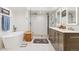 Bright bathroom featuring a large shower, double sink, and a soaking tub at 7500 E Dartmouth Ave # 8, Denver, CO 80231