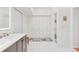Modern bathroom featuring a long white vanity, built in cabinets, with a rug and bench at 7500 E Dartmouth Ave # 8, Denver, CO 80231
