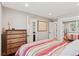 Bright bedroom with wood floors, dresser, and closet with mirrored doors at 7500 E Dartmouth Ave # 8, Denver, CO 80231