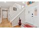 Bright entryway featuring hardwood floors, a staircase, and a decorative stained glass window at 7500 E Dartmouth Ave # 8, Denver, CO 80231