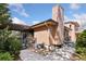 Cozy home exterior features a pergola-covered deck, wood siding, and a well-maintained yard at 7500 E Dartmouth Ave # 8, Denver, CO 80231