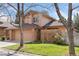 Charming home featuring a brick facade, two-car garage, and well-maintained lawn at 7500 E Dartmouth Ave # 8, Denver, CO 80231
