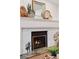 Bright fireplace with whitewashed brick surround and decorative mantle displays tasteful decor at 7500 E Dartmouth Ave # 8, Denver, CO 80231
