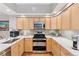 Bright kitchen with stainless appliances, ample counter space, and light wood cabinetry at 7500 E Dartmouth Ave # 8, Denver, CO 80231