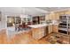 Open concept kitchen with stainless appliances, island, and an adjacent dining area with a chandelier at 7500 E Dartmouth Ave # 8, Denver, CO 80231