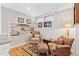 Sitting room featuring a bookshelf, comfortable chairs, and a hardwood floor at 7500 E Dartmouth Ave # 8, Denver, CO 80231