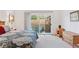 Bedroom with an outdoor patio with furniture, wood floors, and neutral carpet under the queen bed at 7500 E Dartmouth Ave # 8, Denver, CO 80231