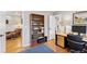 Open office space with hardwood floors, built-in shelving, and plenty of natural light at 7500 E Dartmouth Ave # 8, Denver, CO 80231