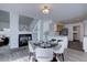 Open dining area featuring a modern table set, fireplace, and easy access to kitchen at 18997 E 51St Pl, Denver, CO 80249