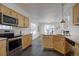 Spacious kitchen with stainless steel appliances, wooden cabinets, and an open layout at 18997 E 51St Pl, Denver, CO 80249