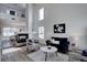 Bright living room featuring a cozy fireplace, high ceilings, and elegant decor at 18997 E 51St Pl, Denver, CO 80249