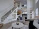 Bright living area with modern staircase, fireplace, high ceilings, and stylish decor at 18997 E 51St Pl, Denver, CO 80249
